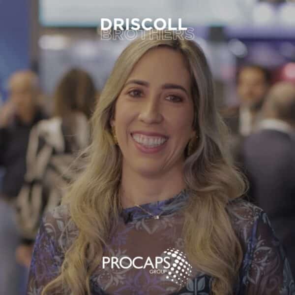 A picture of Rosella Del Vecchio in the Procaps booth giving her testimonial with the Procaps logo and Driscoll Brothers logo